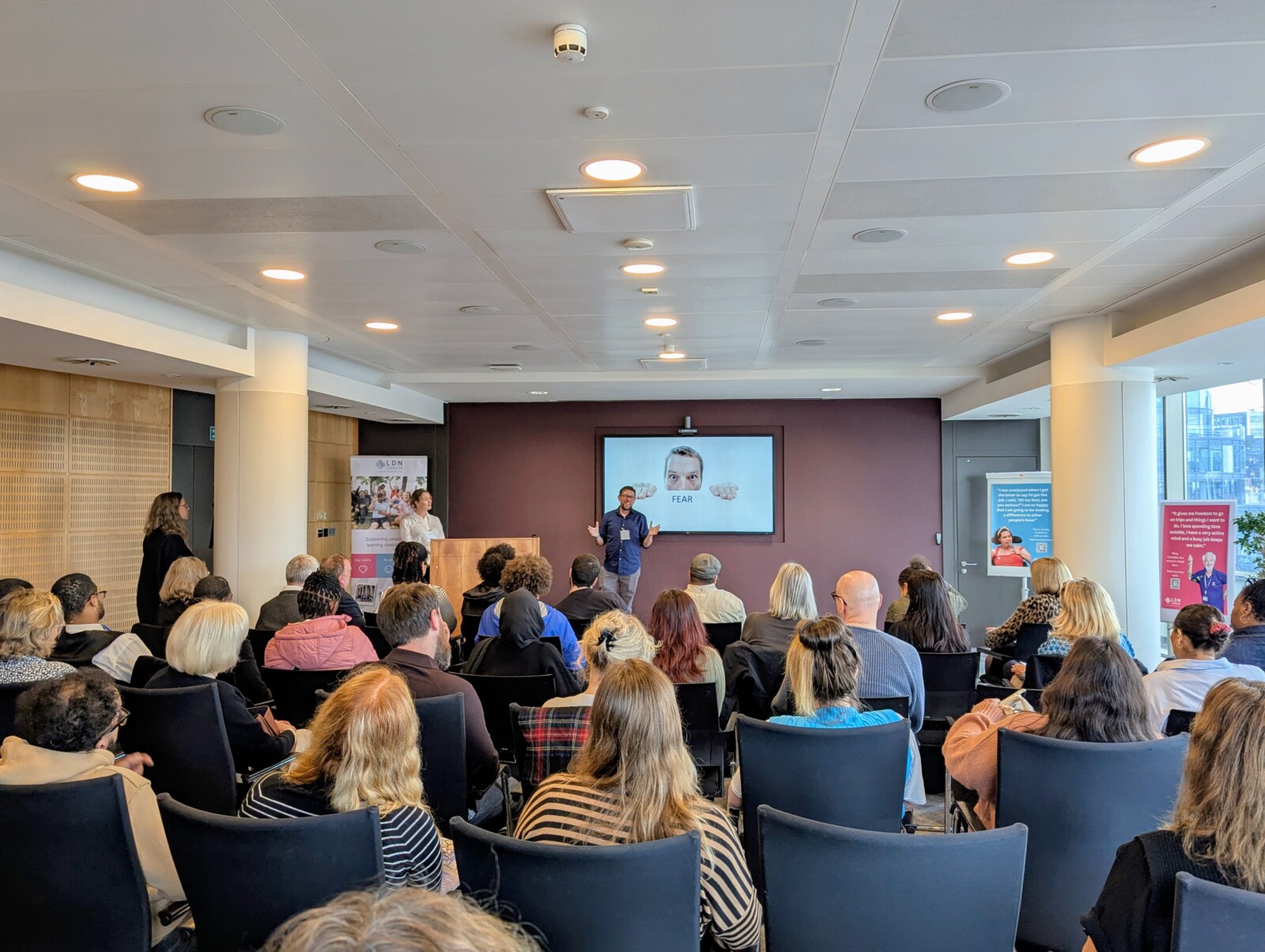 A man standing and speaking to an audience
