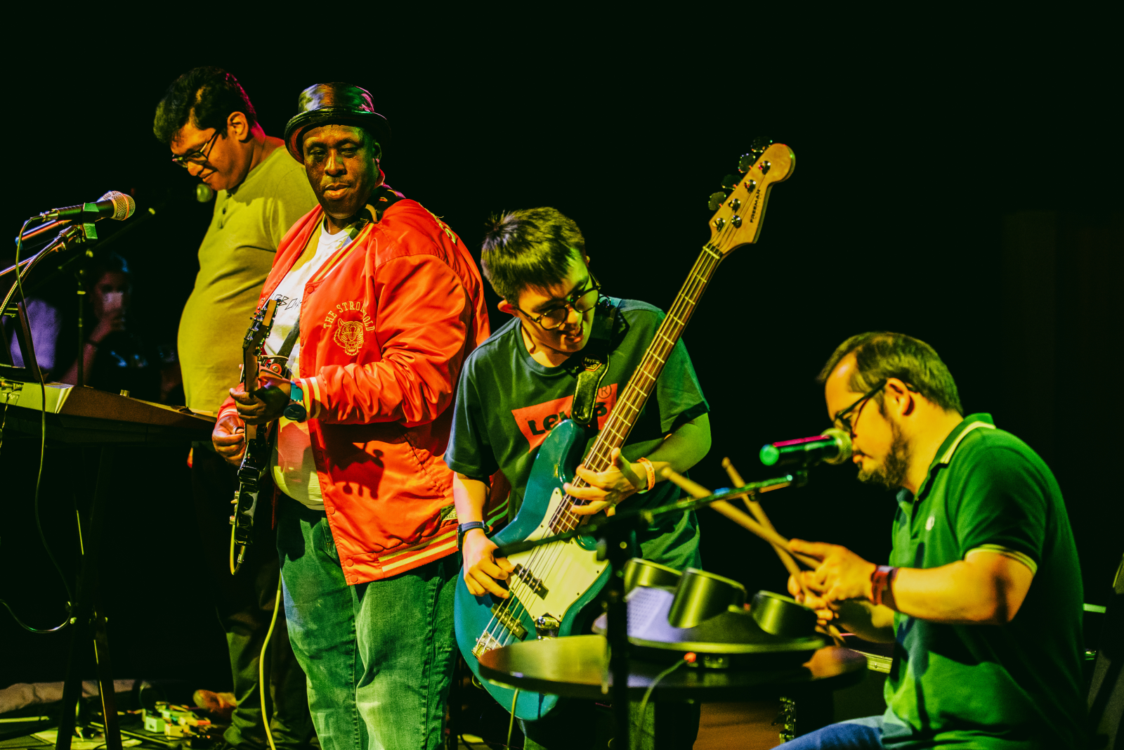 A group of people playing instruments onstage