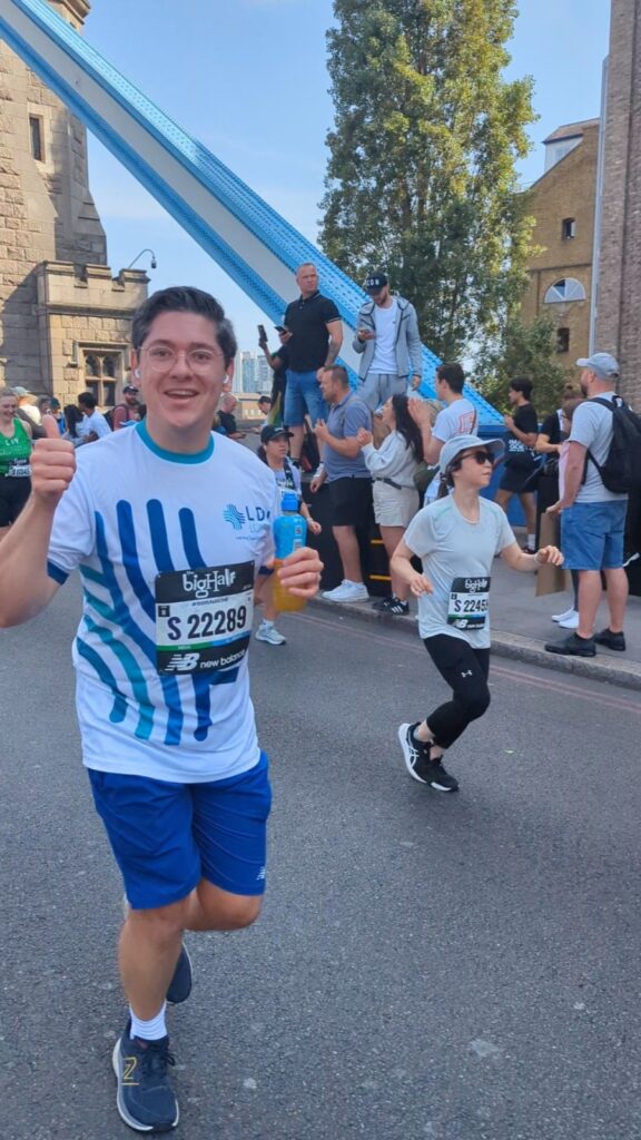 Runner giving a thumbs up while running in the Big Half race.