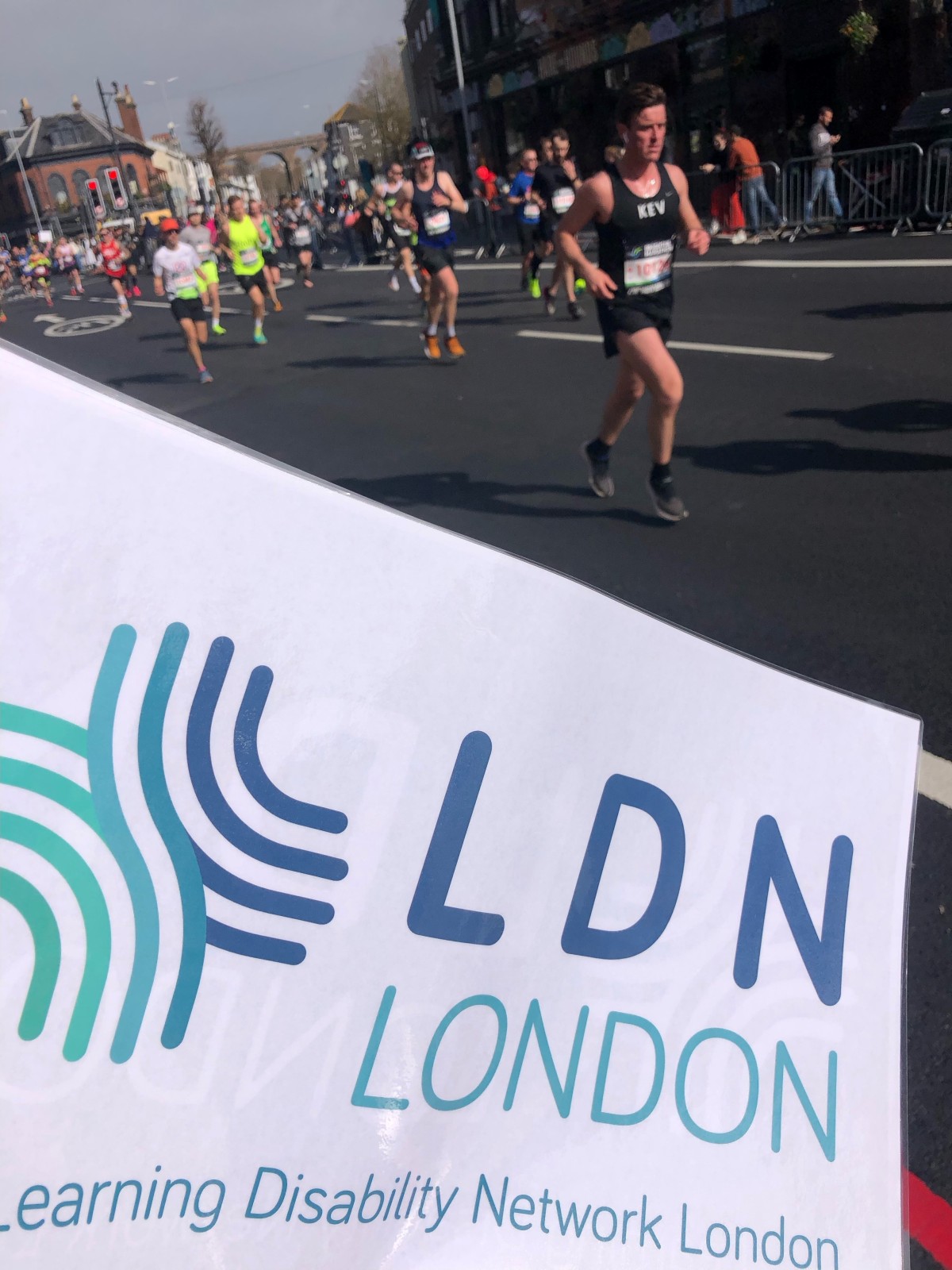 Brighton Marathon Group of runners racing along a city street during a marathon.