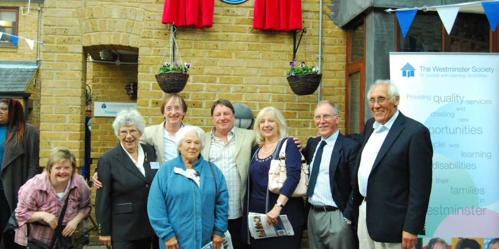 A group of people stand outside the head office building