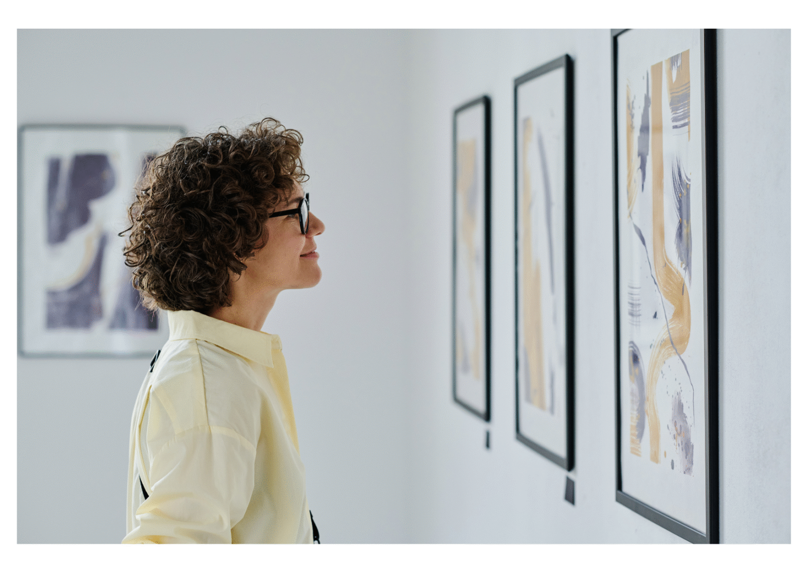 A woman looks at an art display on a wall