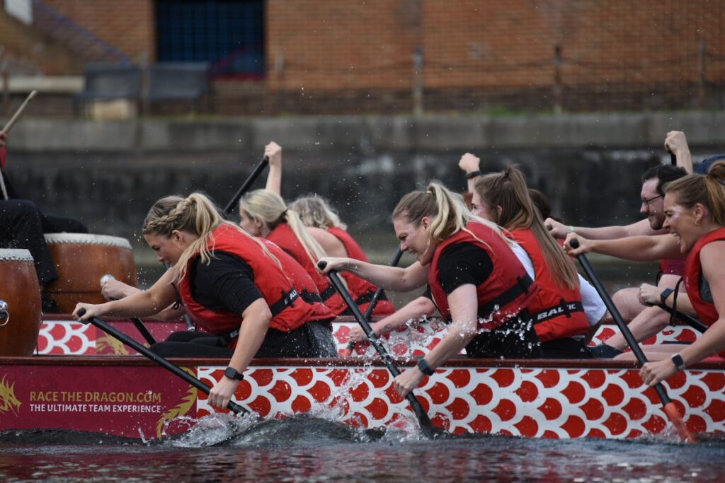 Dragon boat team paddling together during a race.
