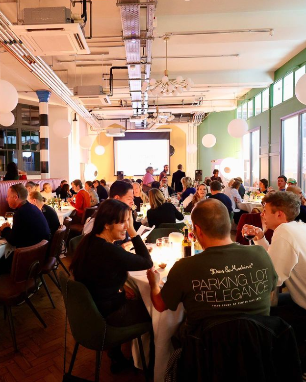 Large group of people seated at tables during fundraising quiz night