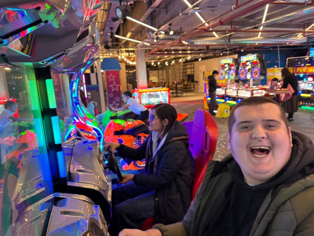 Young person having fun at the arcade on a racing game
