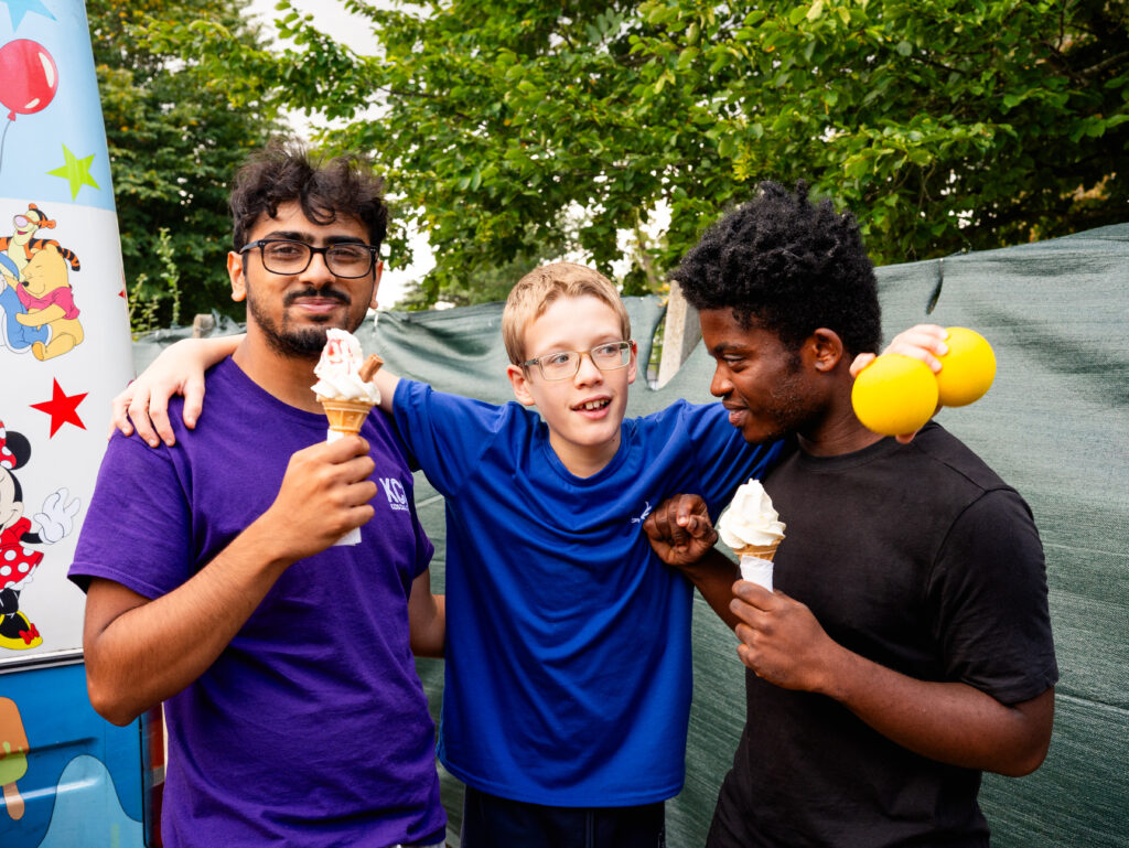 Three people enjoying ice cream together at an outside KCA