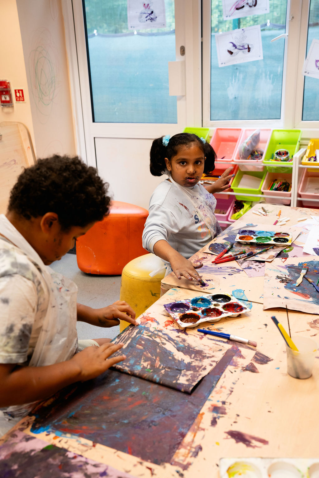 Two children painting in an art room