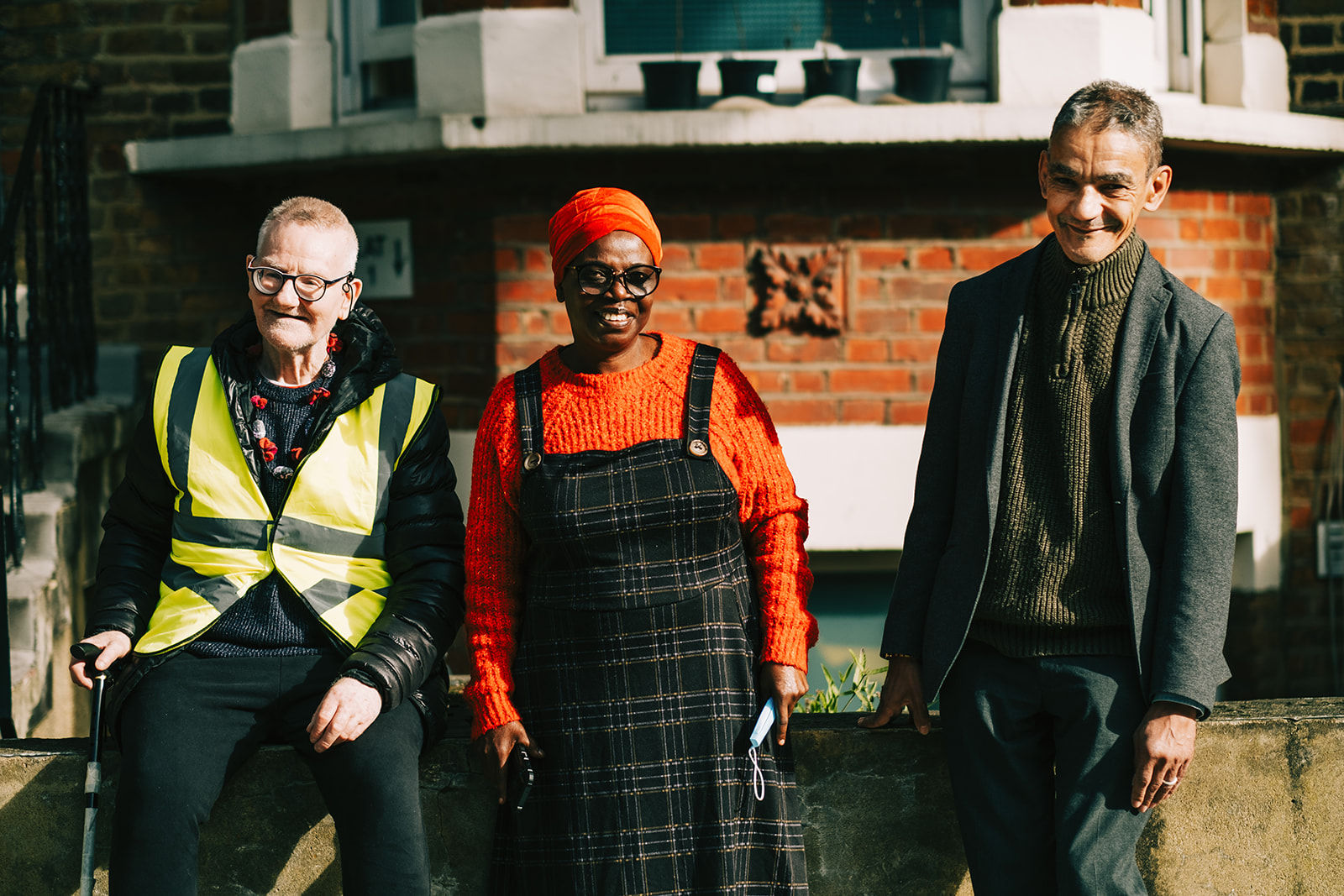 Three people smile at the camera