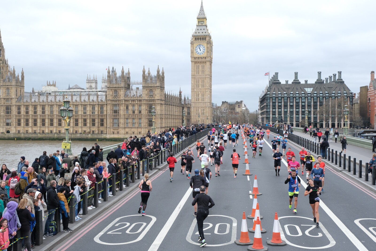 Runners crossing Westminster Bridge during a race with the Houses of Parliament in the background.