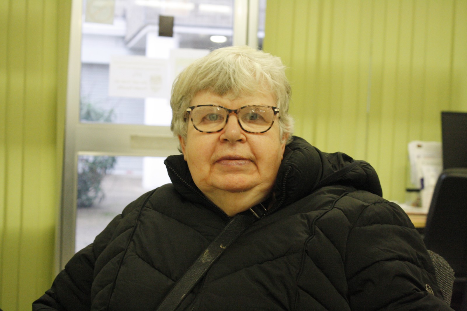 A person inside is seated and looking at the camera