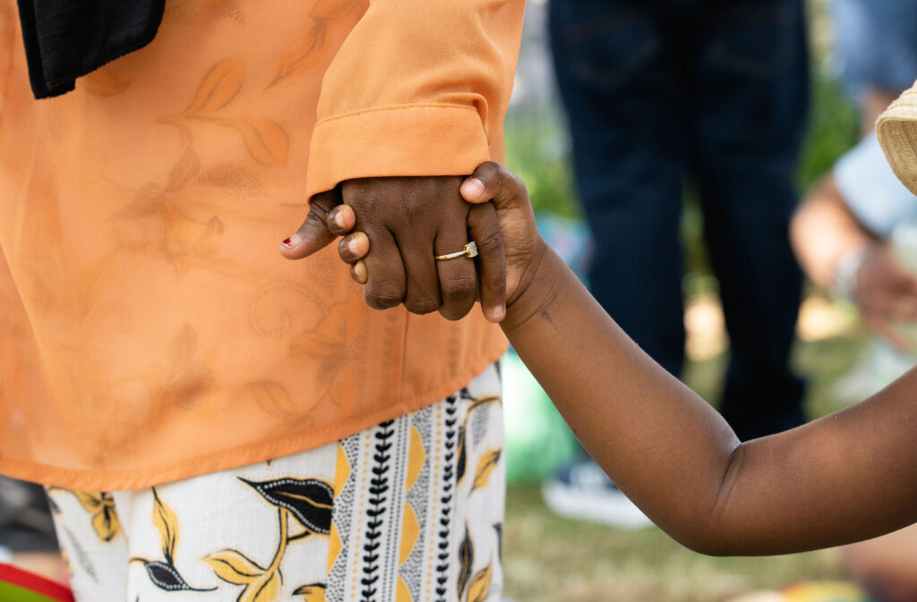 Child and parent holding hands