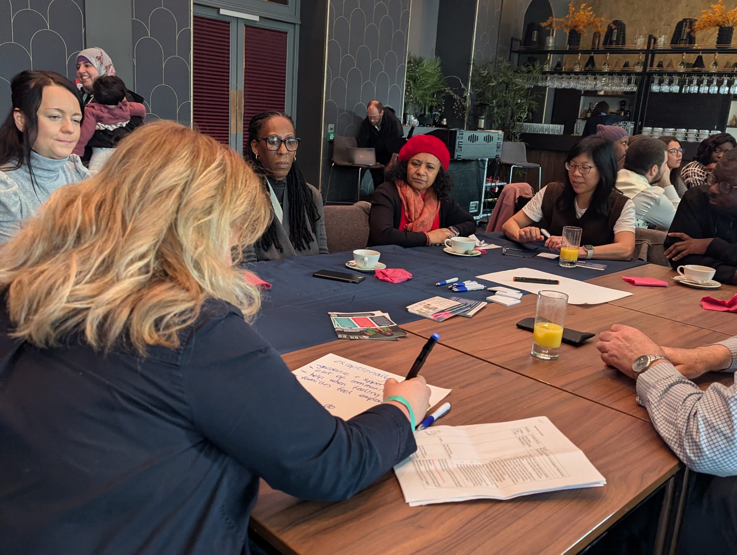 Group of parents sitting aorund a table having a discussion
