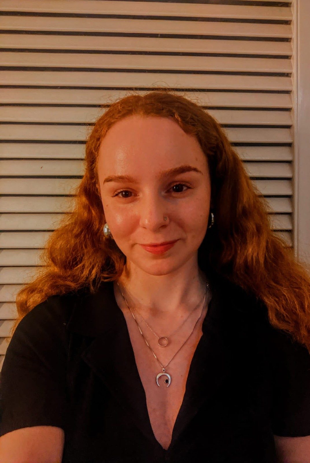 A woman smiles gently at the camera