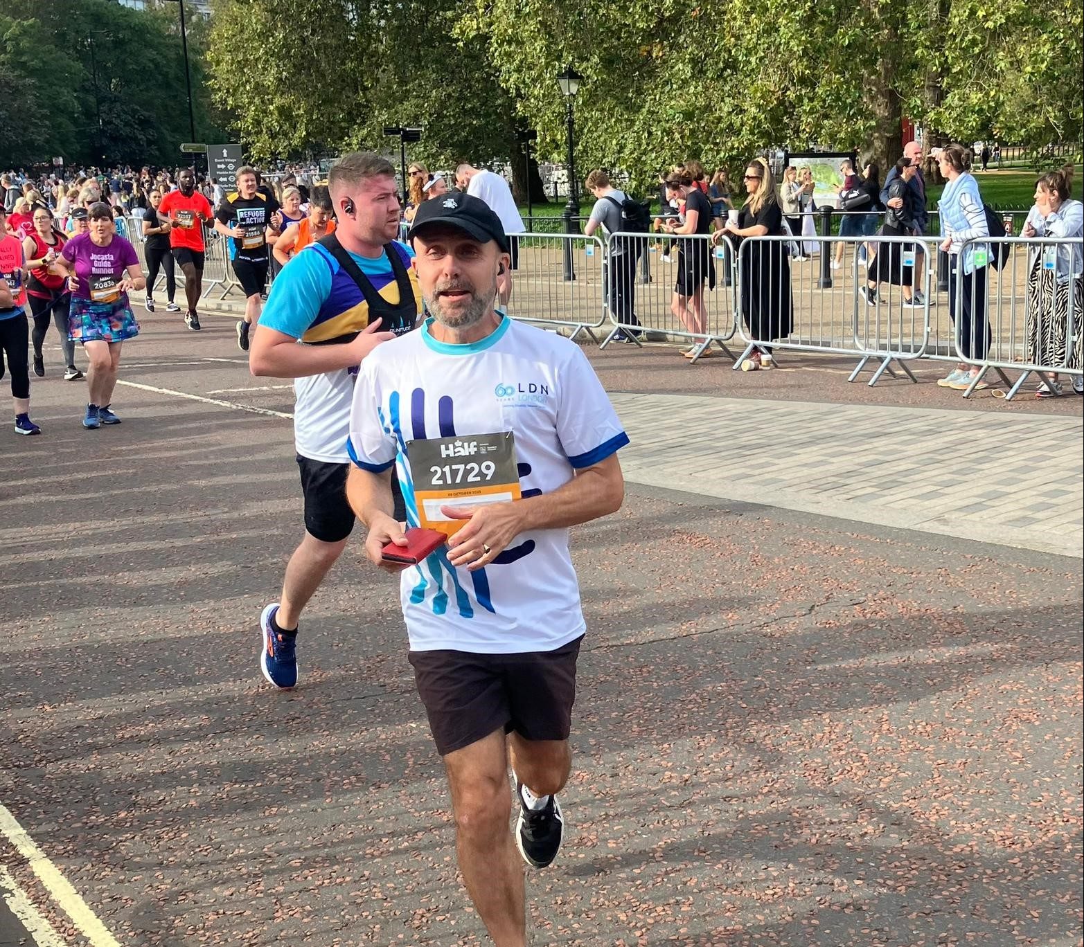 Runner wearing a LDN London Running top running along a closed road at the Royal Parks Half Marathon.