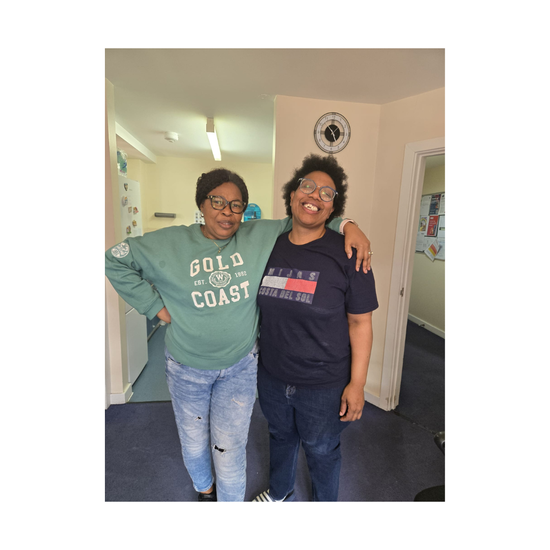 Two people standing close and smiling