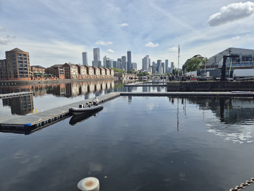 View of the water at Surrey Docks Watersports Centre with Canary Wharf in the background